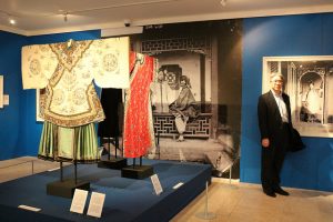 Gowns in the Women's Gallery, John Thomson Exhibition - with visitor alongside to show the scale of the large prints